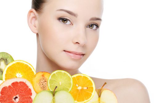 beautiful clean health female face with fresh fruits